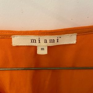 Orange open shoulder shirt size M